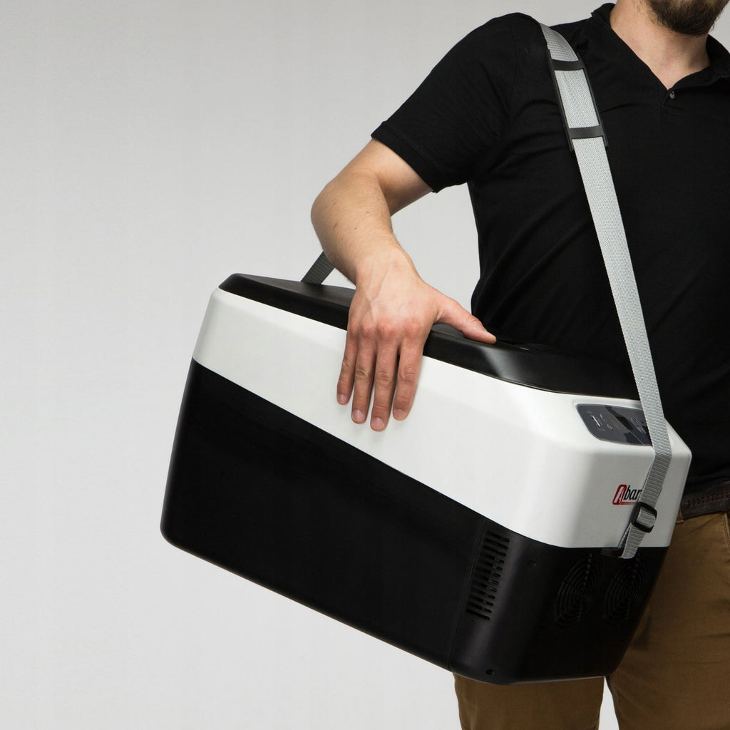 Person carrying a black and white cooler bag on a plain background